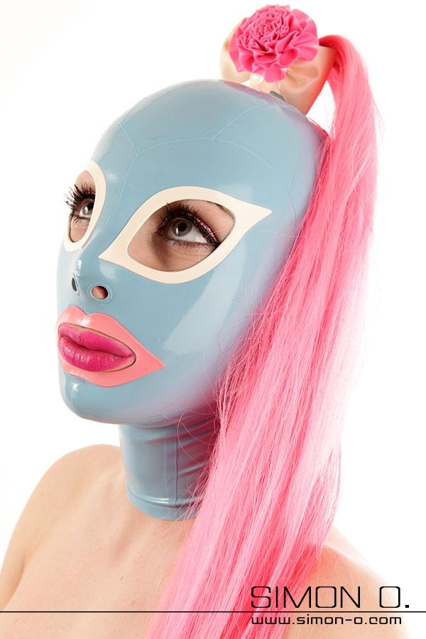 Latex mask with ponytail A light blue latex mask with a pink hairpiece, the eyes are white and the mouth is outlined in pink.