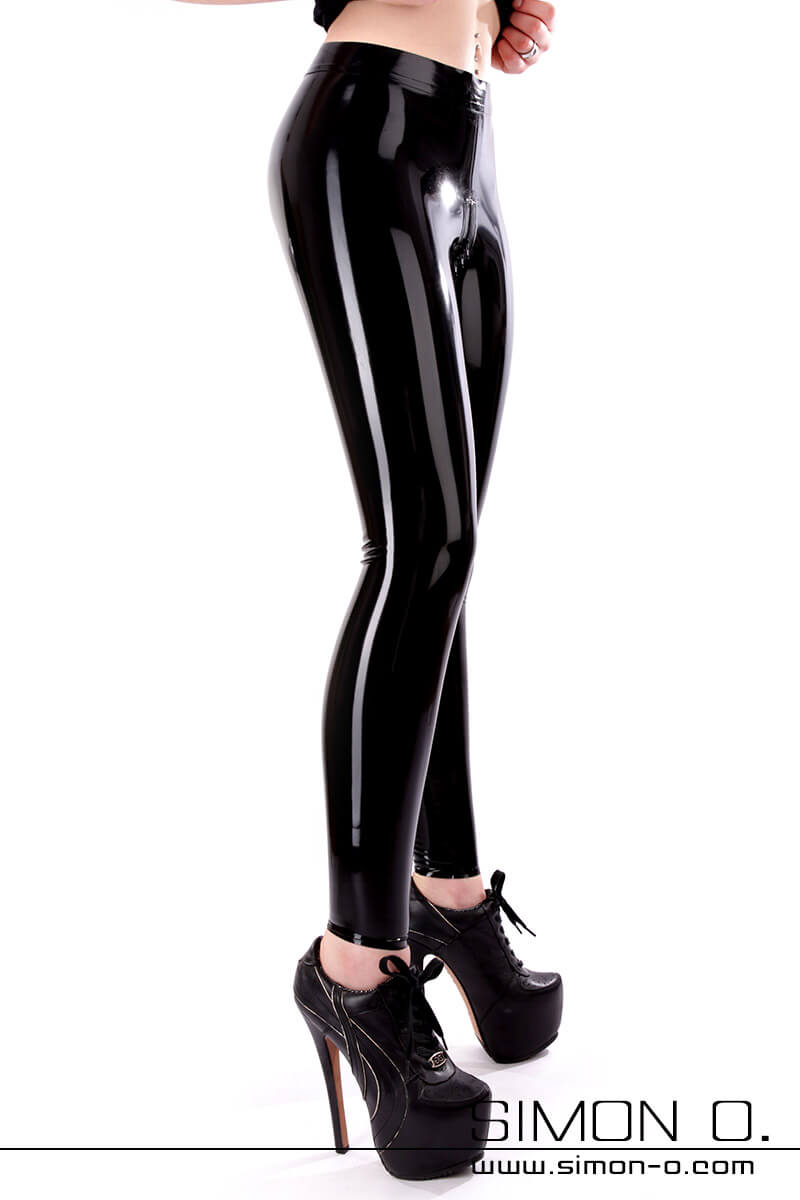 Latex leggings skin-tight in black with zip Women's legs in skin-tight, shiny latex leggings with a zip through the crotch. The lady wears platform high heels