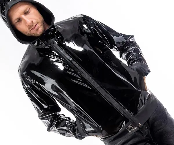 A man wears a sporty latex jacket in black with a hood.