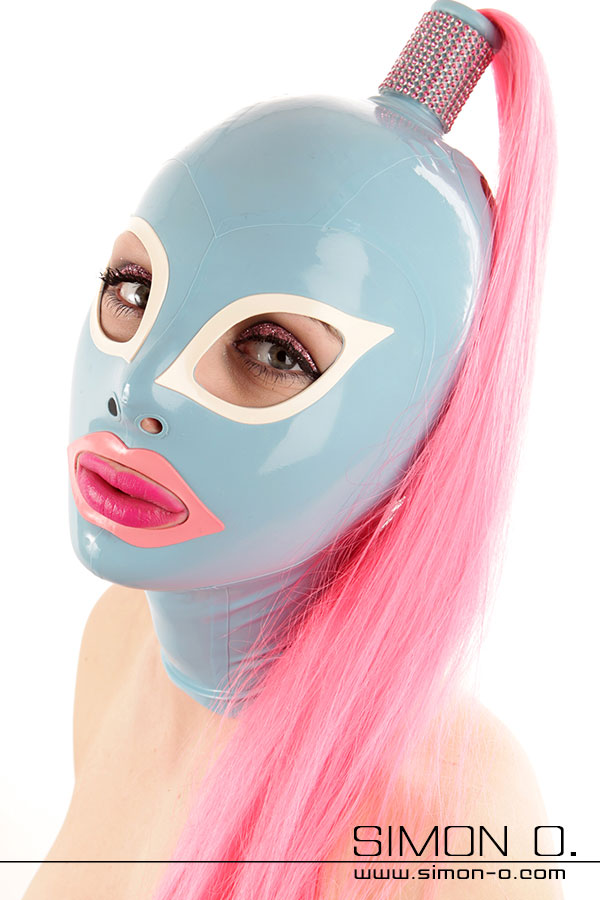Latex mask with hairpiece A woman is wearing a light blue latex mask with a pink hairpiece, her eyes are white and her mouth is outlined in pink.