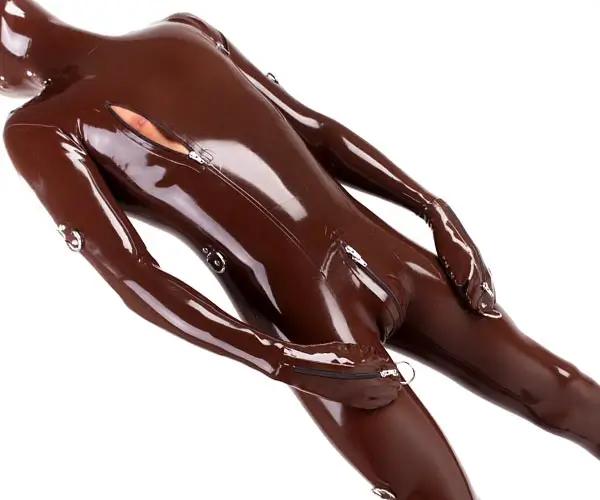 A man wears a latex bondage catsuit with mittens. The suit is open at the nipples.
