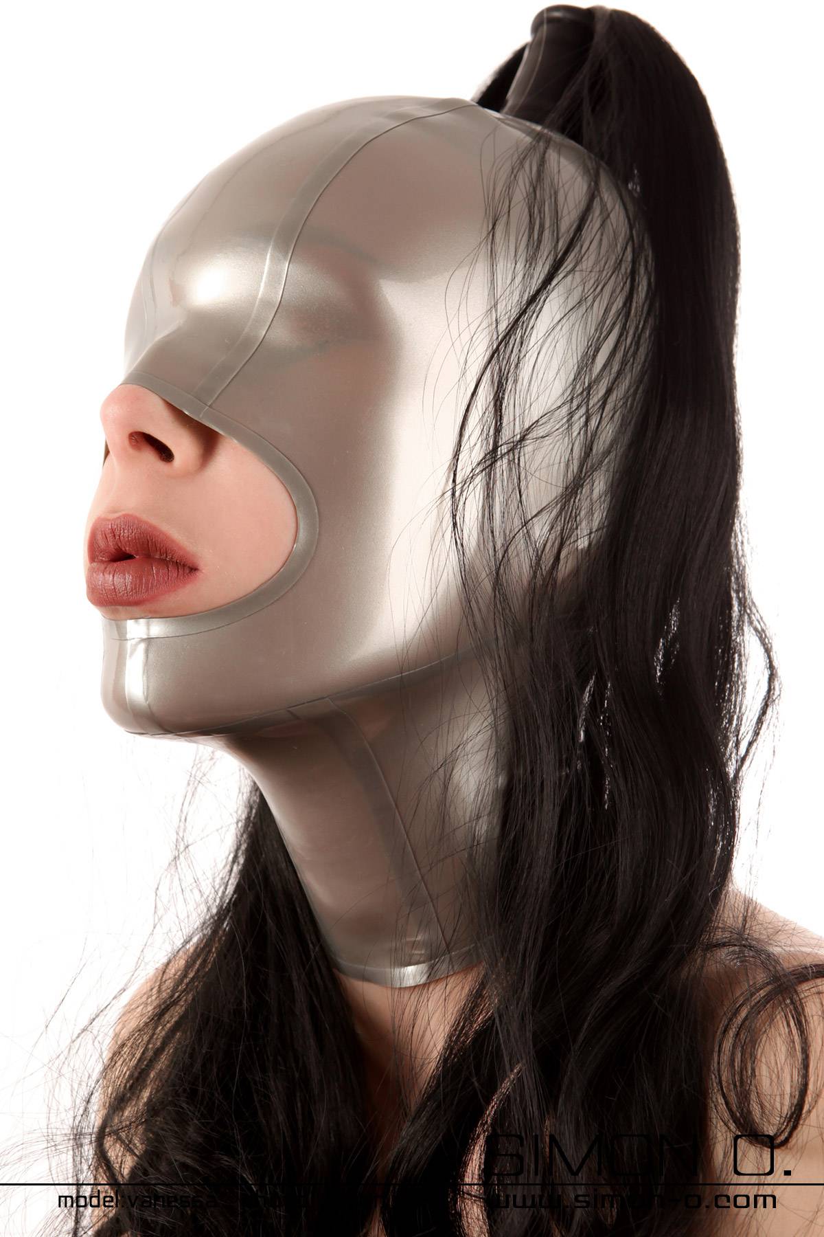 Latex mask mouth open with hairpiece One person wears a shiny silver latex hood with a black hairpiece falling down.