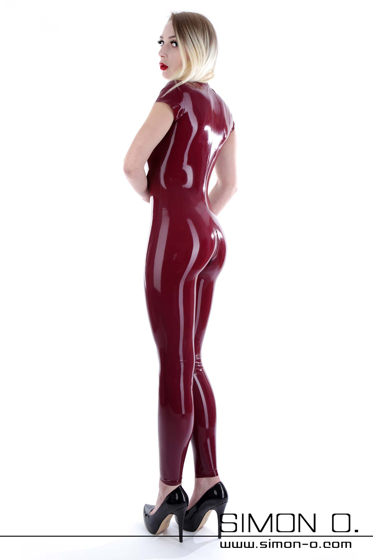 Short sleeve latex catsuit Skin tight short sleeve latex catsuit with crotch zipper seen from behind
