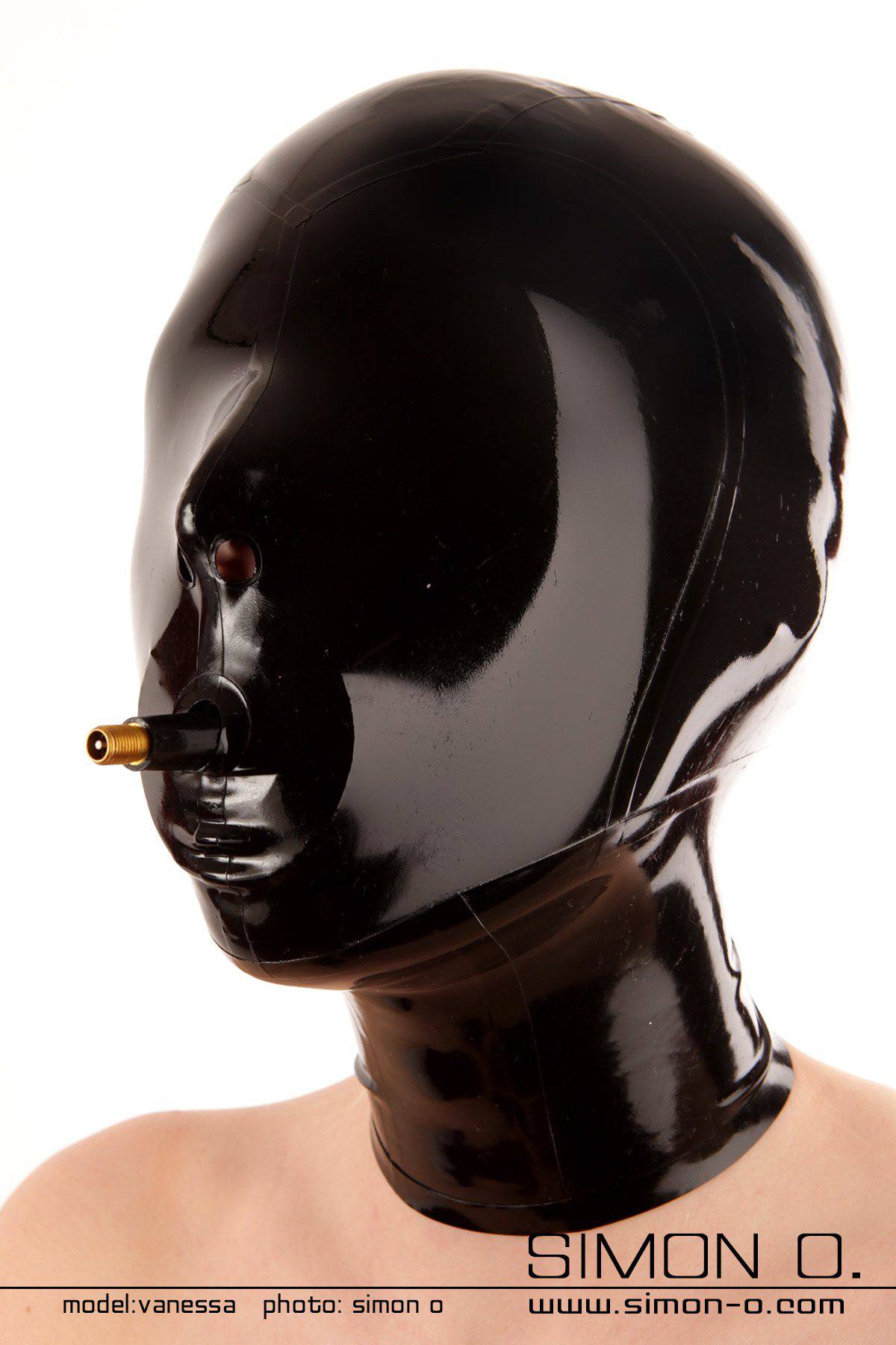 Blindfold slave latex hood with gag A women wears a tight shiny Blindfold slave latex hood with gag in black
