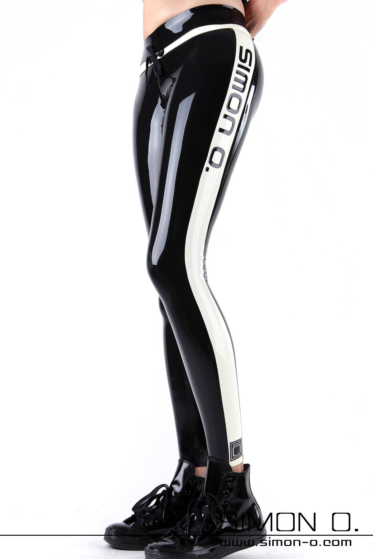 Latex Yoga Shine Leggings Person stands in latex yoga shiny leggings with "Simon O." printed on the side, paired with black boots, against a white background.