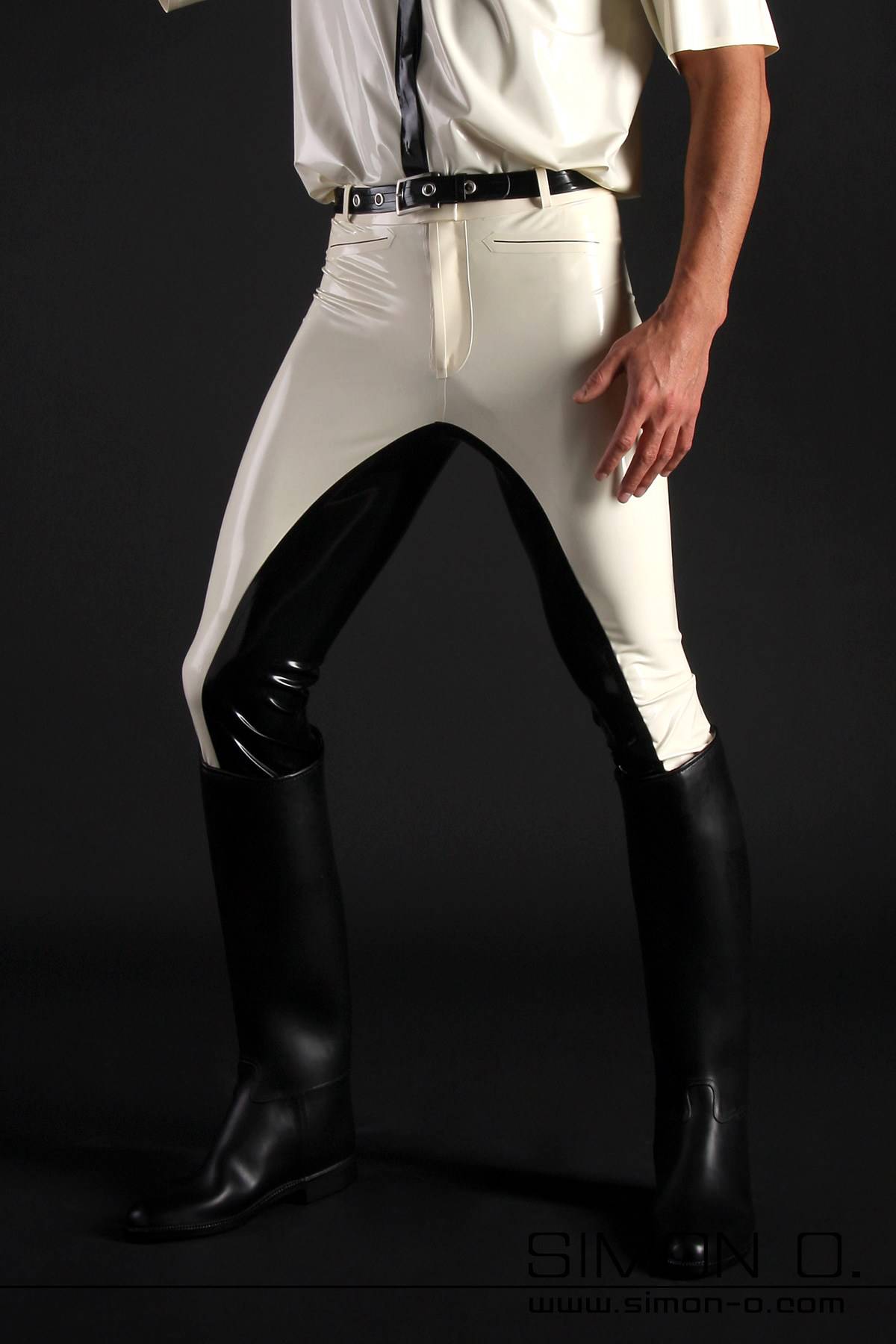 Men's latex riding breeches A man is wearing black and white latex breeches and riding boots.