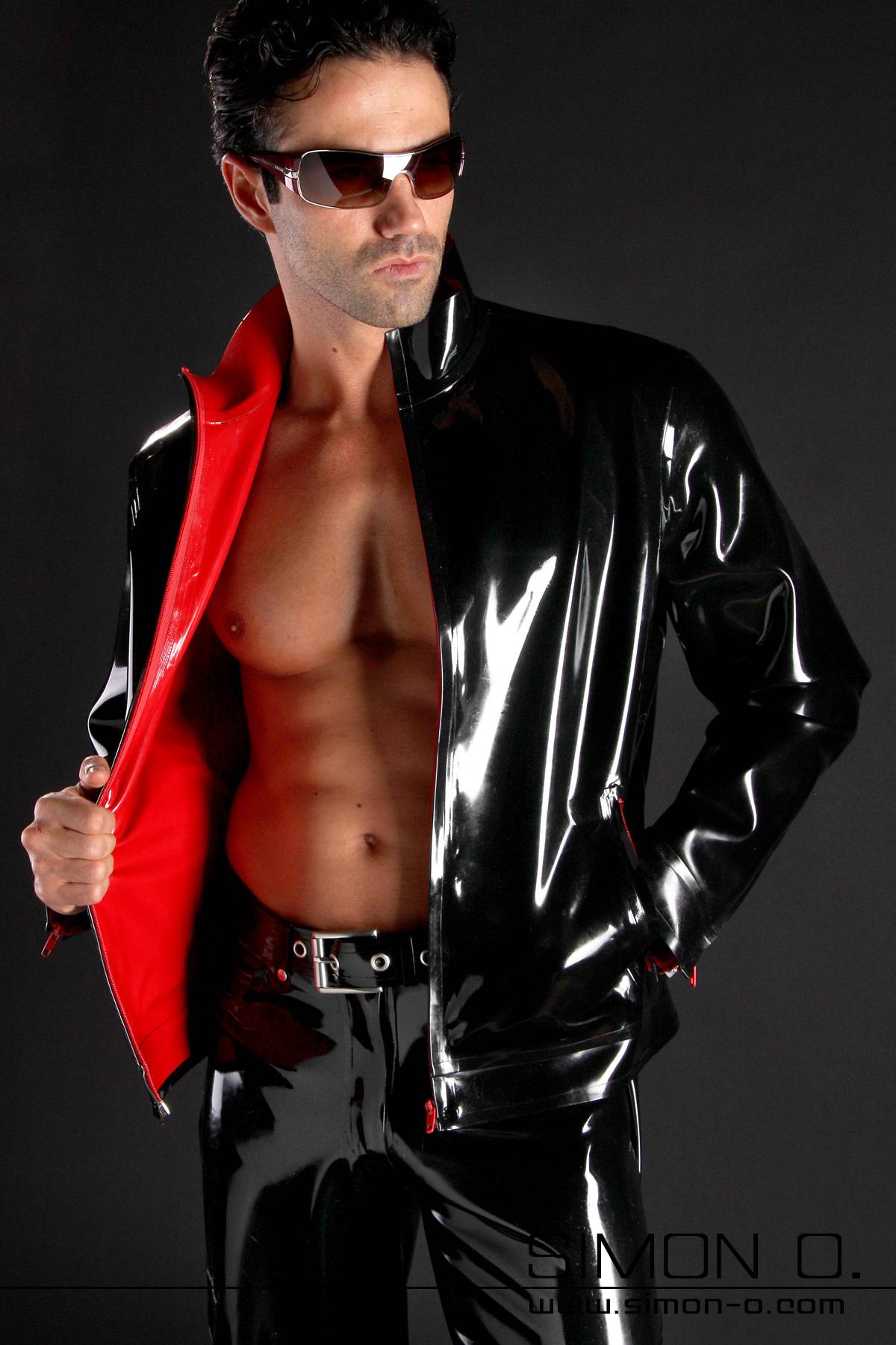 Latex Jacket Black with Red A man wears a black shiny latex jacket with red latex lining