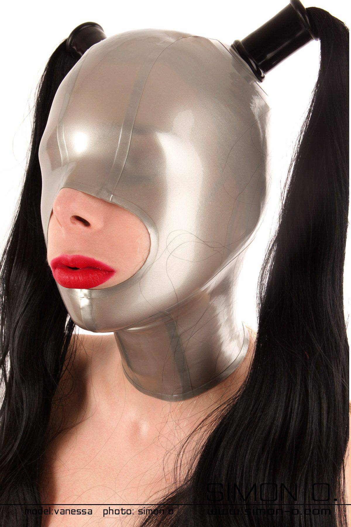 Latex mask mouth open with 2 hairpieces One person is wearing a smooth, metallic-looking latex mask hood with two black ponytails falling down.