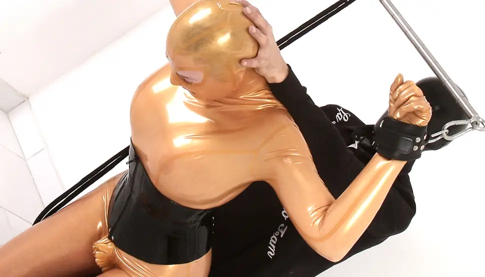 Latex bondage girl tied up A woman in a skin-coloured latex catsuit is tied up and subjected.