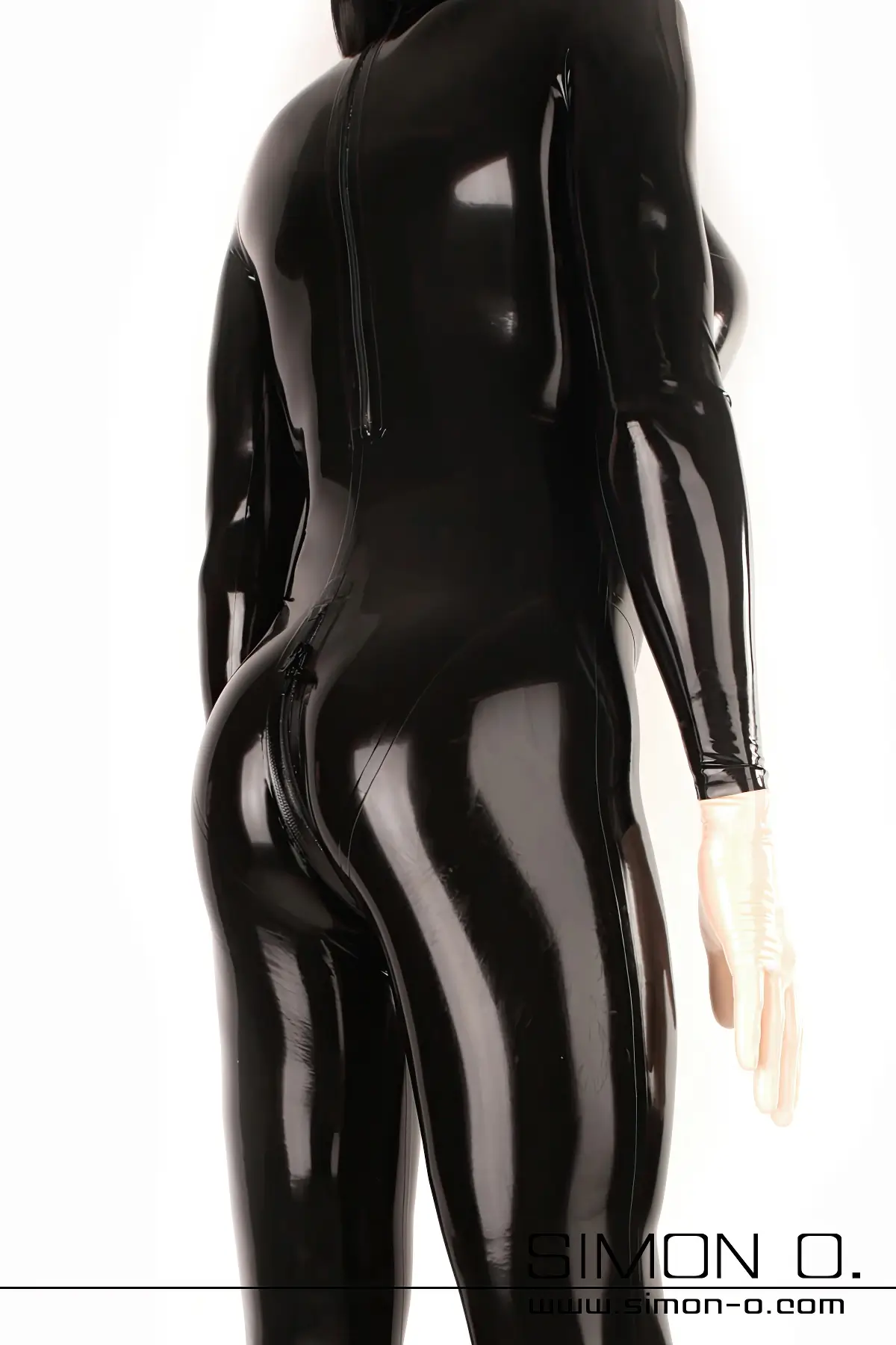 A skin-tight latex catsuit in black with silicone breasts and a zip at the crotch