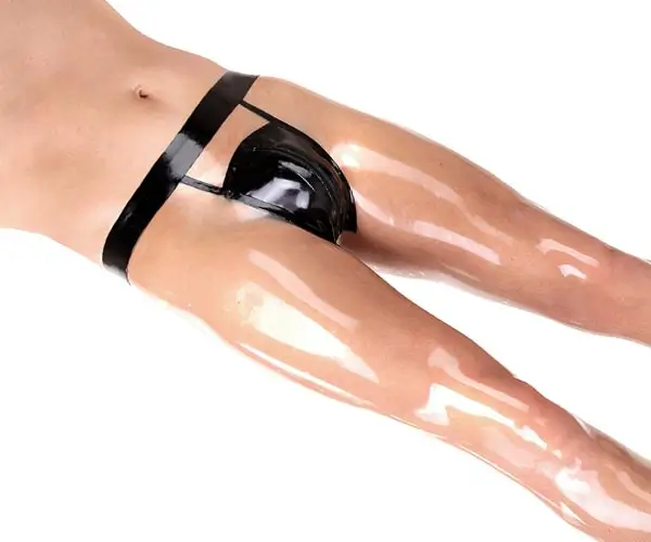 A man in shiny latex underwear in transparent combined with black, you can see the legs and a part of the upper body.