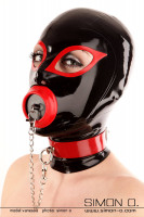 Preview: A woman wears a black latex mask with a collar. The mouth is closed with a stubble which hangs from a chain on the collar.