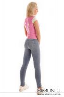 Vorschau: Eine blonde Frau trägt ein hautenges Latex Top in Rosa mit kurzen Ärmeln in Kombination mit einer hellen Jeans