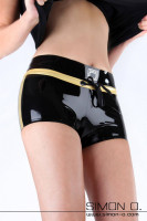 Preview: A woman wears a shiny latex hot pant in black with gold