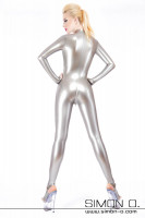 Preview: A blonde woman from behind in a skintight silver latex catsuit with zipper in the crotch area