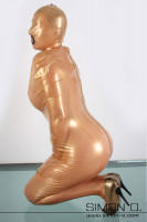 Preview: A woman kneels on the ground in a lockable latex bondage bag with mask