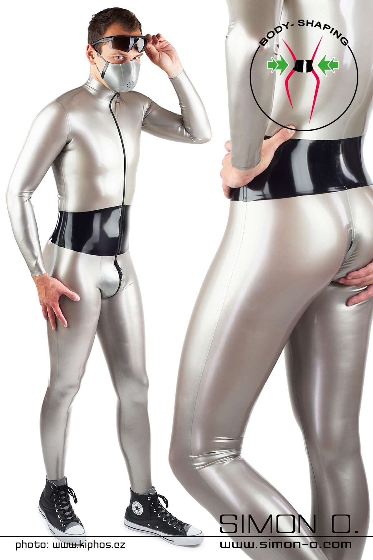 A man wears a shiny latex catsuit in silver with an integrated wide corset belt in black - seen from behind