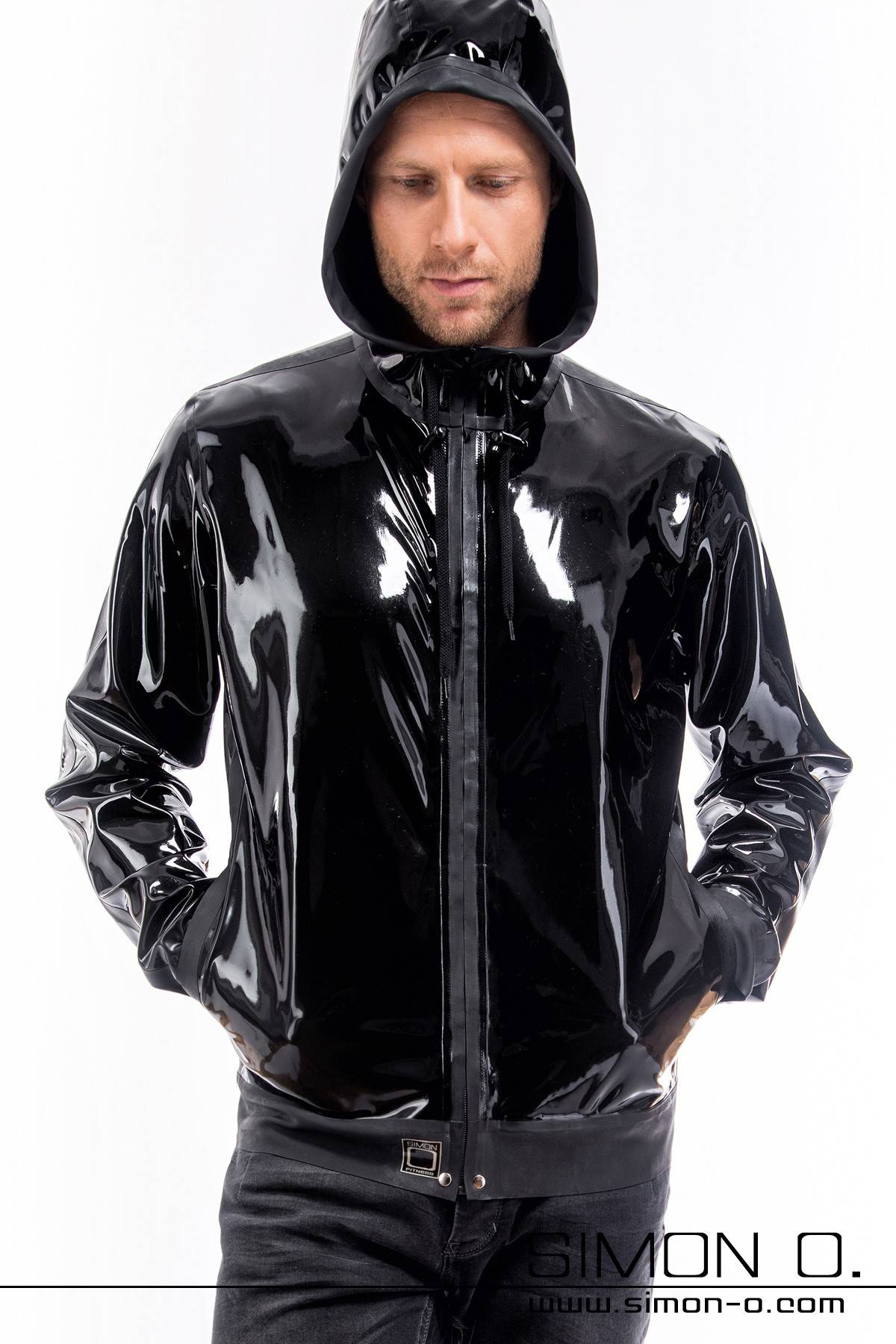 A man wears a shiny black latex jacket with hood and pockets in black