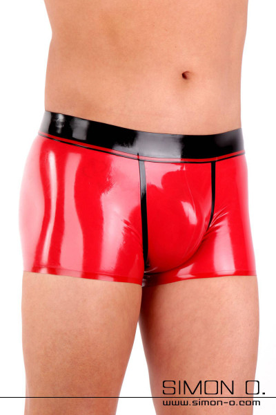 A man wears a skintight shiny men's latex underpants in red with black waistband