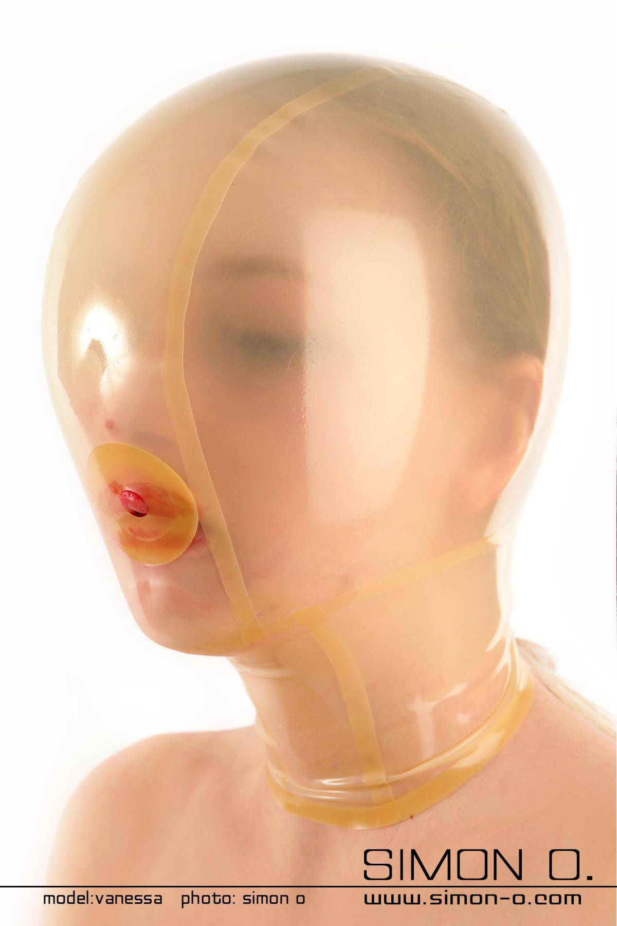 A woman wears a transparent latex hood with a small breathing hole for breathing reduction games.