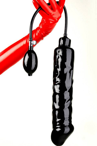 Extremely large inflatable black latex dildo with pump and tube held by one hand