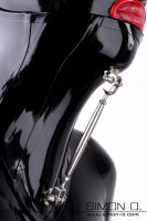 Preview: A woman with hood wears a black neck corset made of latex with adjusting screw