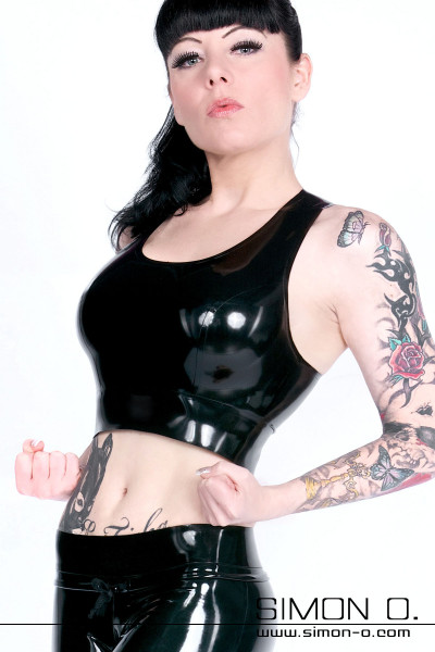 A woman wears a black tight shiny top made of latex