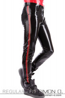 Preview: A man wears black latex jeans with red stripes on the sides and thin green stripes - seen from the front