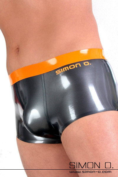 A man wears a shiny latex underpants in metallic colours with a waistband in contrasting colour.