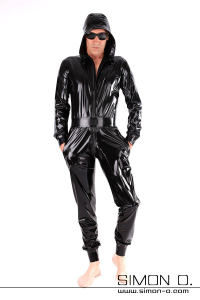 A man in a shiny black latex suit with hood pockets similar to a shiny jogging overall