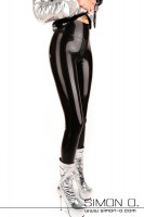 Preview: A woman is wearing black skin tight high gloss latex pants in black. In the crotch area there is a zipper and she wears silver ankle boots